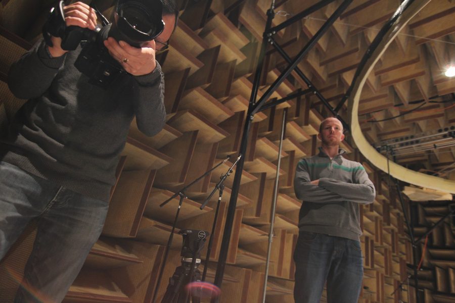 Andrew and Patrick Shen filming inside an anechoic chamber lined with acoustic wedges